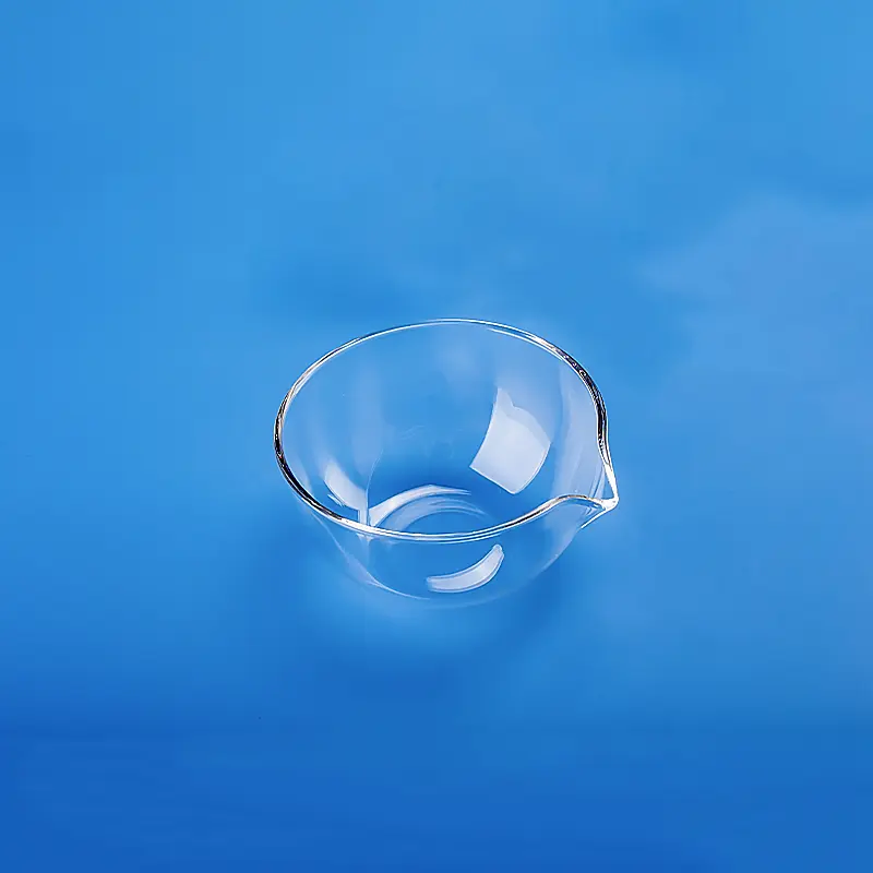 Single clear quartz evaporating dish with spout against a blue background.