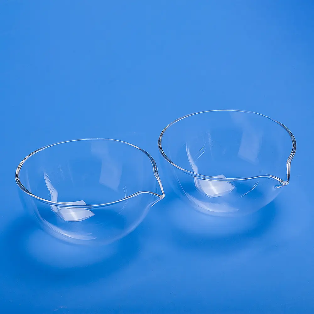 Pair of clear quartz evaporating dishes with pouring spouts.