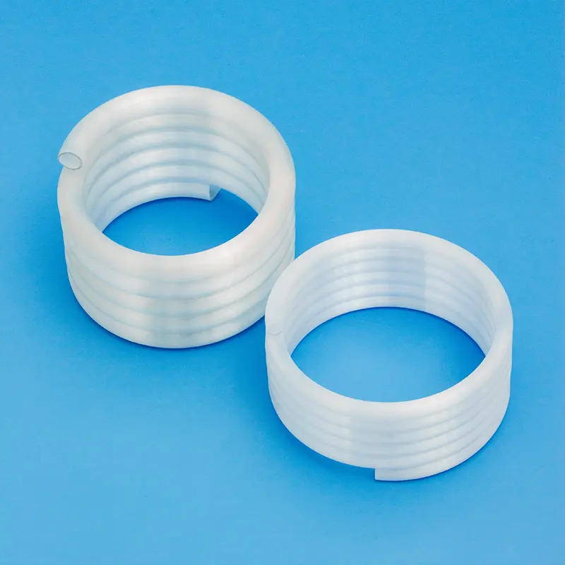 Two custom-made frosted or opaque quartz spiral tube coils of different winding tightness.