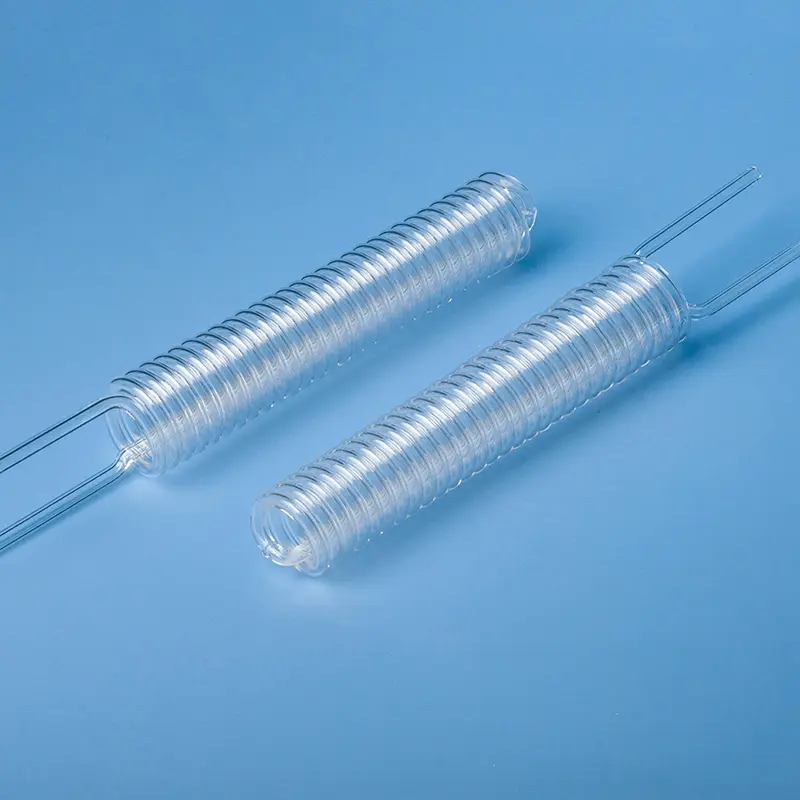Pair of clear, elongated quartz spiral tubes (helical coils) for laboratory or industrial use.