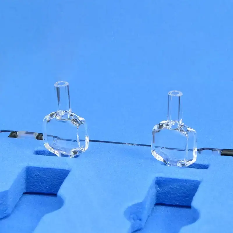 Pair of quartz fluorescence flow cells with top connecting tubes, presented in blue protective foam packaging