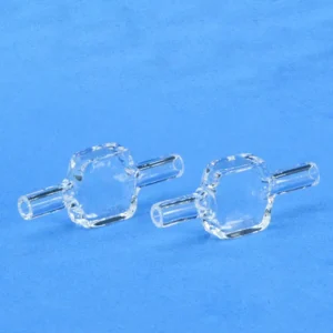 Pair of identical quartz fluorescence flow cells for spectroscopy, shown on a light blue background