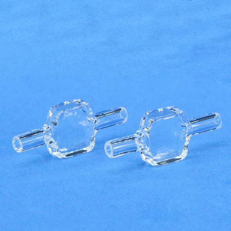 Pair of identical quartz fluorescence flow cells for spectroscopy, shown on a light blue background