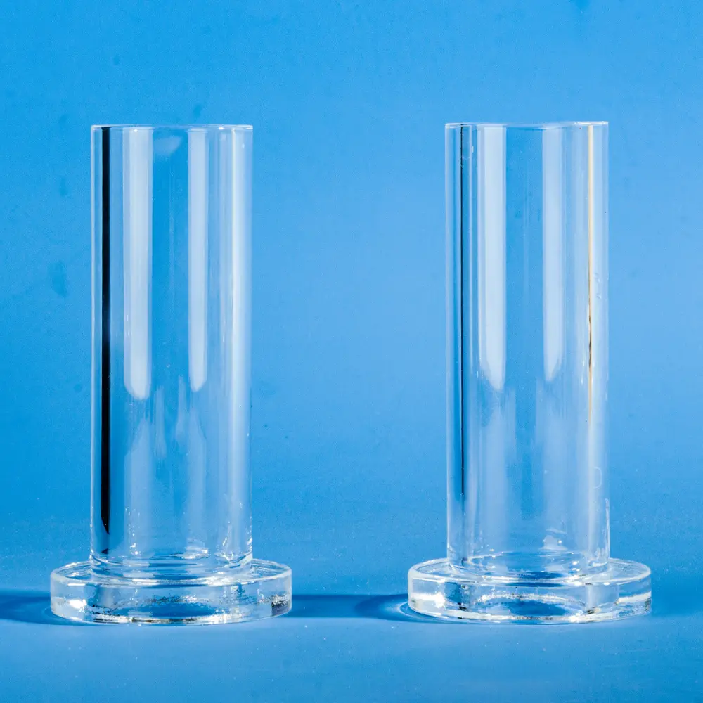 Two identical clear quartz tubes with integrated flanges, shown from a front-on perspective