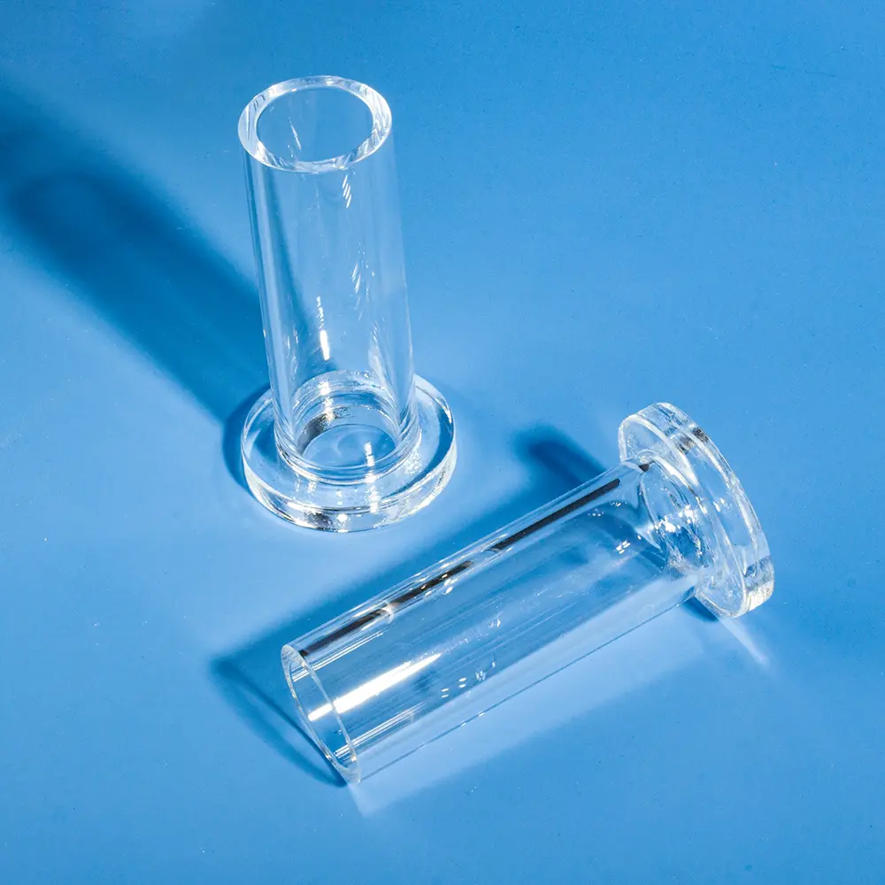 One flanged quartz tube standing and one lying down, displaying both upright and side profiles