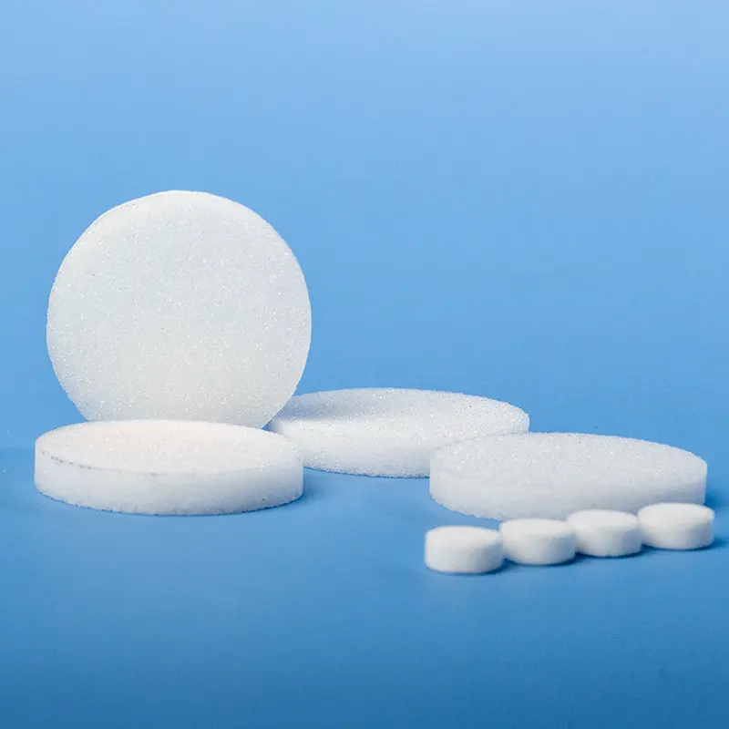 Collection of white sintered quartz filter discs in multiple diameters, some stacked, on a blue background